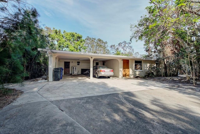 ranch-style home featuring a carport