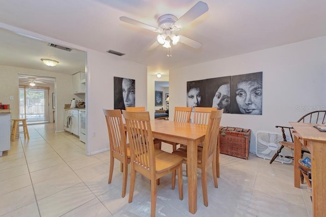 dining area with ceiling fan and light tile patterned floors