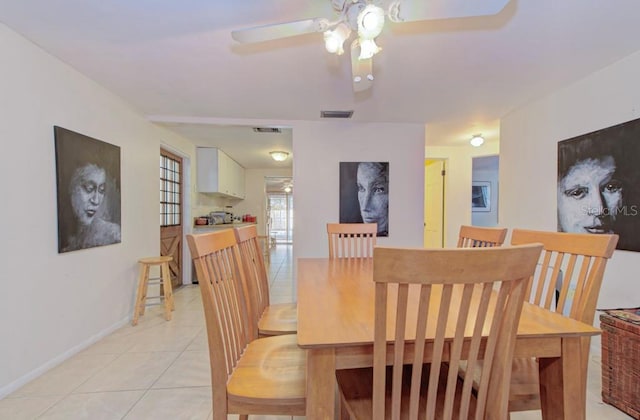 tiled dining room featuring ceiling fan