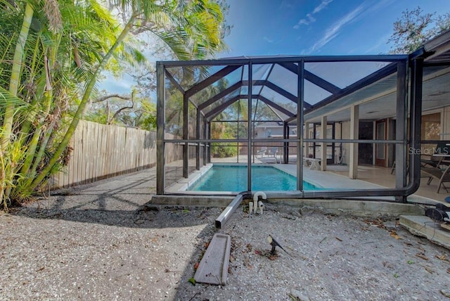 view of pool with glass enclosure