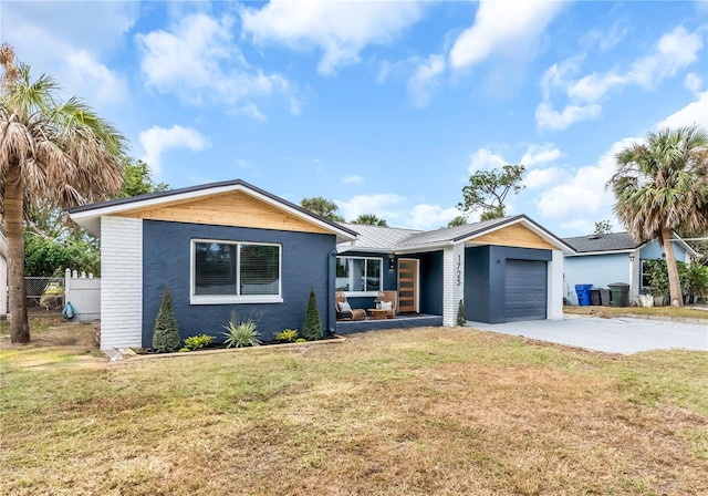 single story home featuring a front yard and a garage