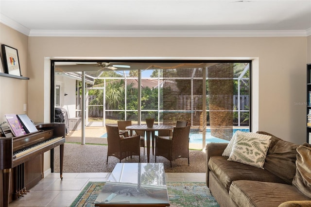 tiled living room featuring ceiling fan, ornamental molding, and a healthy amount of sunlight