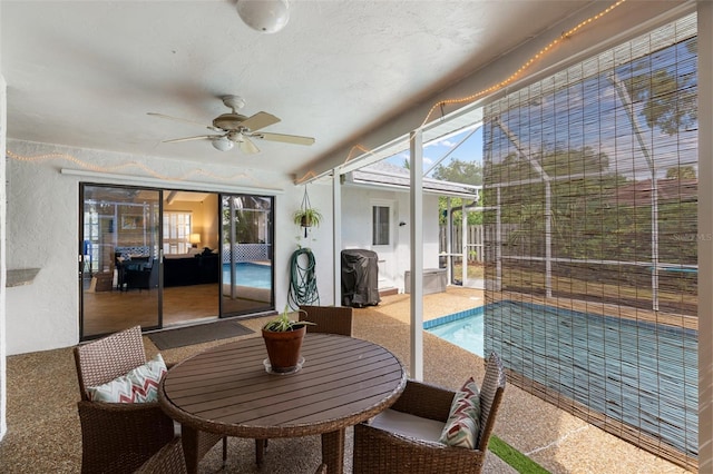 sunroom with a wealth of natural light and ceiling fan