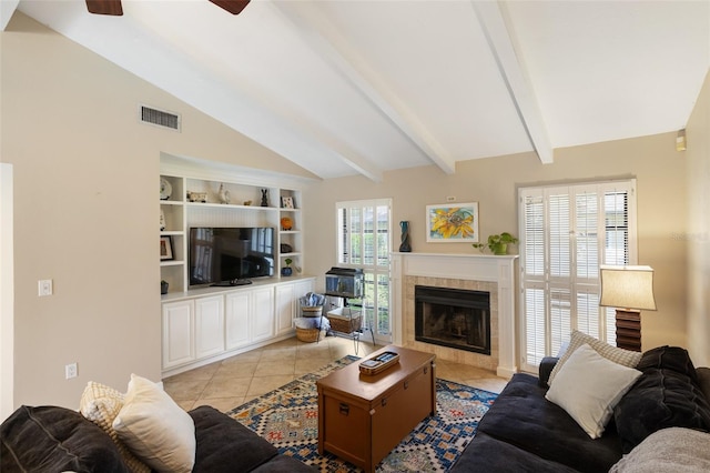 tiled living room featuring a tiled fireplace and vaulted ceiling with beams