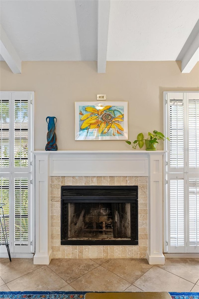 interior details featuring beam ceiling and a fireplace