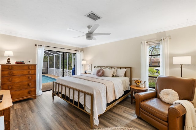 bedroom with multiple windows, access to exterior, crown molding, and dark hardwood / wood-style flooring