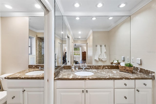 bathroom with ornamental molding, toilet, and vanity