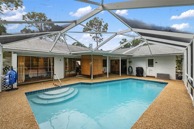 view of pool with a lanai and a patio area