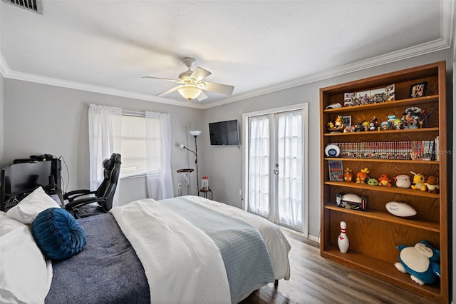 bedroom featuring hardwood / wood-style floors, crown molding, ceiling fan, and access to exterior