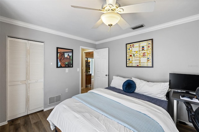 bedroom featuring crown molding, dark wood-type flooring, and a closet