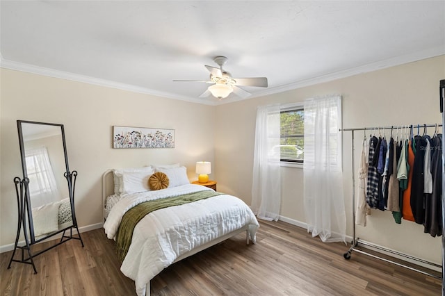 bedroom with wood-type flooring, ornamental molding, and ceiling fan