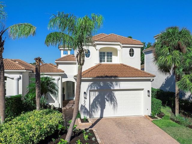 mediterranean / spanish house with a garage