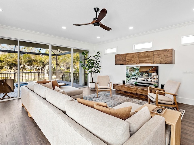 living room featuring ornamental molding, plenty of natural light, and dark wood-type flooring