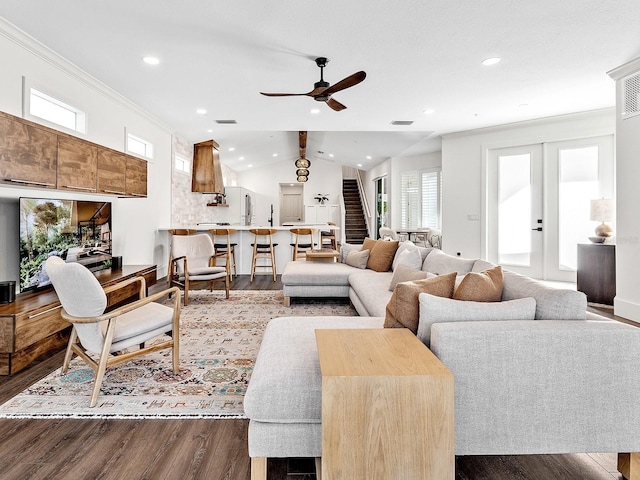 living room with hardwood / wood-style flooring, ceiling fan, ornamental molding, vaulted ceiling, and french doors