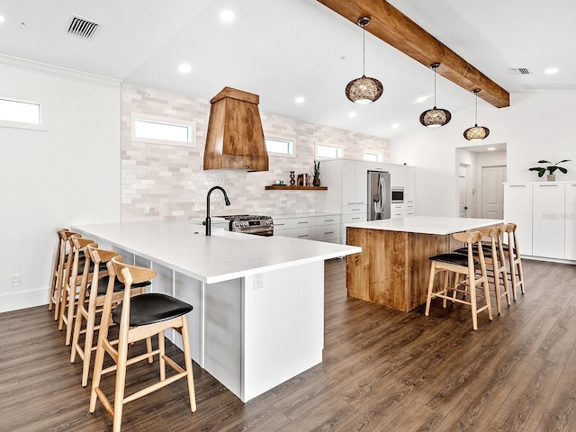 kitchen featuring pendant lighting, kitchen peninsula, sink, and white cabinets