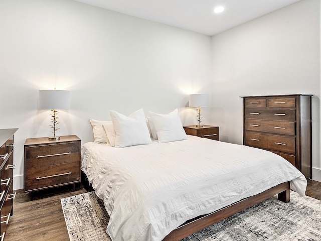 bedroom with dark hardwood / wood-style flooring