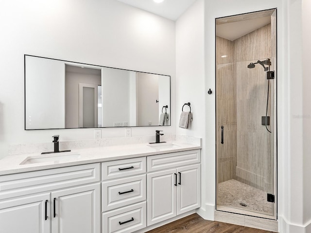 bathroom with vanity, hardwood / wood-style flooring, and walk in shower