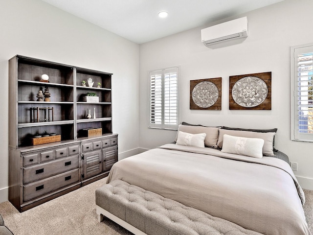 bedroom featuring an AC wall unit and carpet