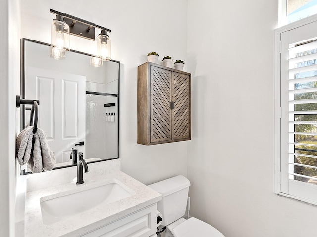 bathroom with vanity, toilet, and walk in shower