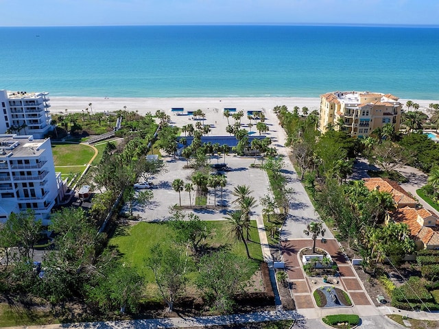 birds eye view of property featuring a water view and a beach view