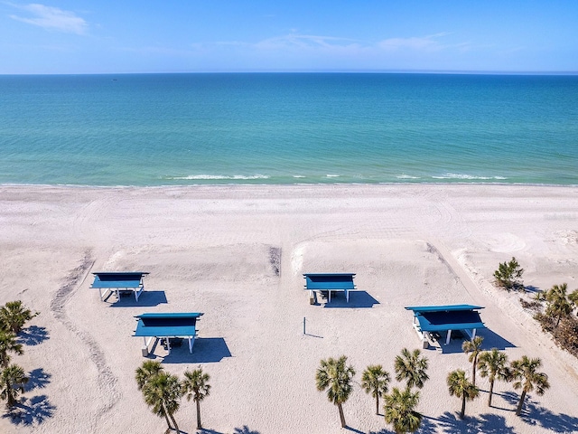 birds eye view of property with a water view and a view of the beach