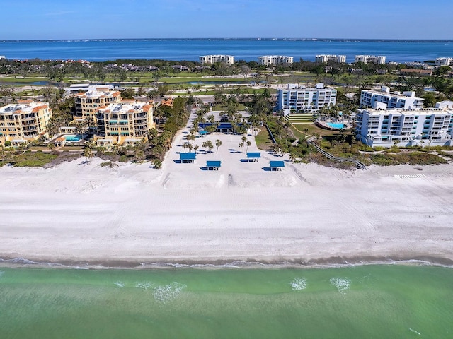 drone / aerial view featuring a beach view and a water view