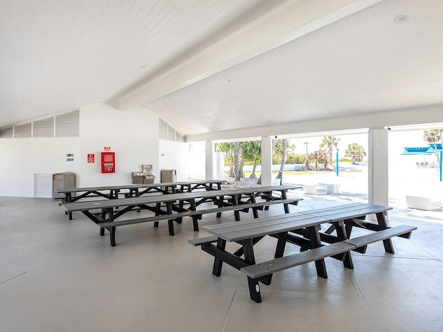 interior space with vaulted ceiling with beams