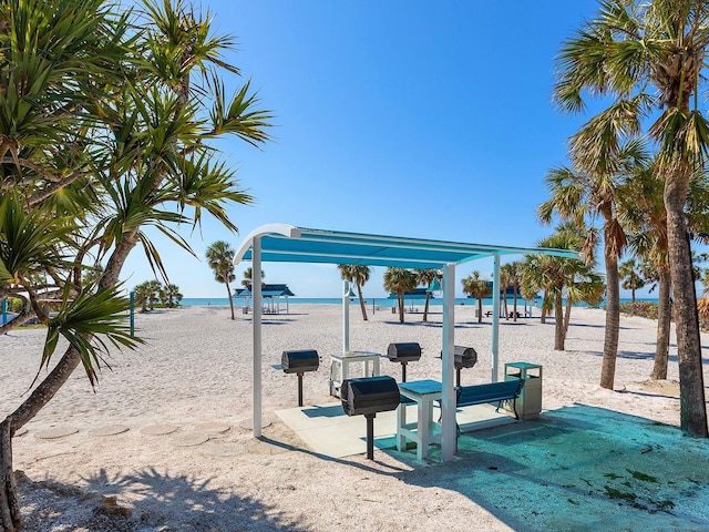 view of jungle gym with a water view and a view of the beach