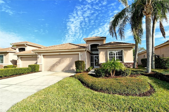 mediterranean / spanish-style home featuring a front yard and a garage