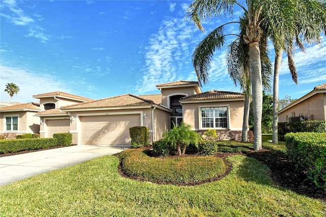 mediterranean / spanish-style home featuring a garage and a front lawn