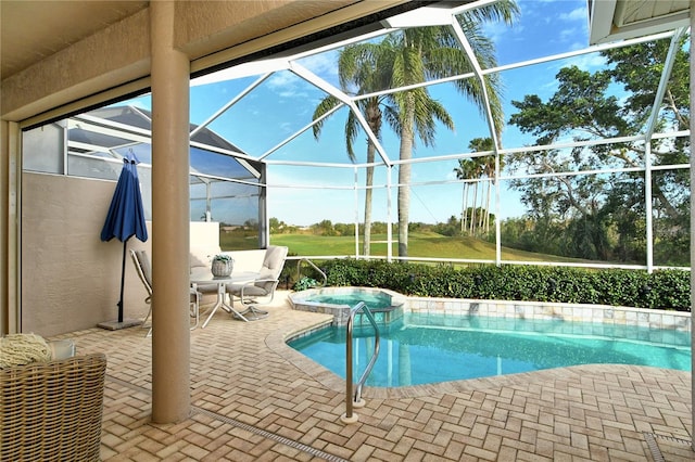 view of swimming pool featuring glass enclosure, an in ground hot tub, and a patio