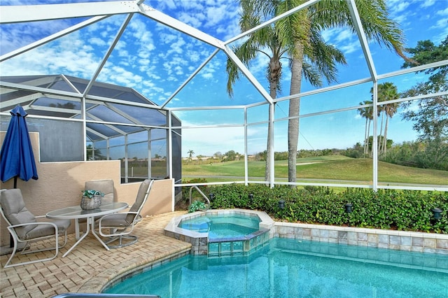 view of swimming pool featuring glass enclosure and an in ground hot tub