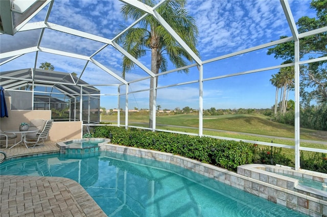 view of pool featuring glass enclosure, an in ground hot tub, and a patio