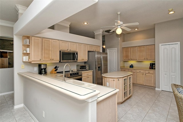 kitchen with kitchen peninsula, crown molding, light tile patterned flooring, and stainless steel appliances