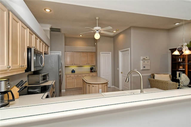 kitchen featuring light brown cabinetry, stainless steel appliances, ceiling fan, light tile patterned floors, and a center island