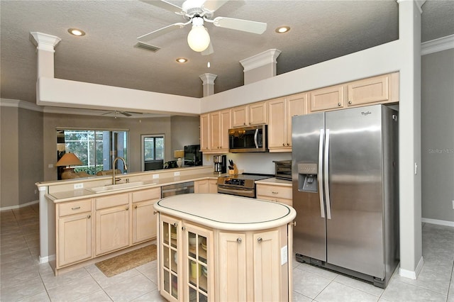 kitchen featuring ceiling fan, light tile patterned floors, kitchen peninsula, and appliances with stainless steel finishes