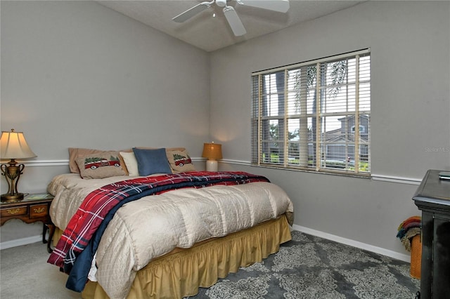 bedroom featuring ceiling fan and dark colored carpet