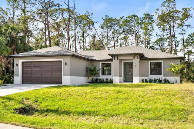 view of front of house featuring a front lawn and a garage