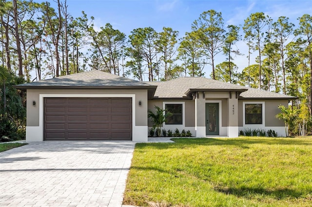 view of front of home featuring a front lawn and a garage