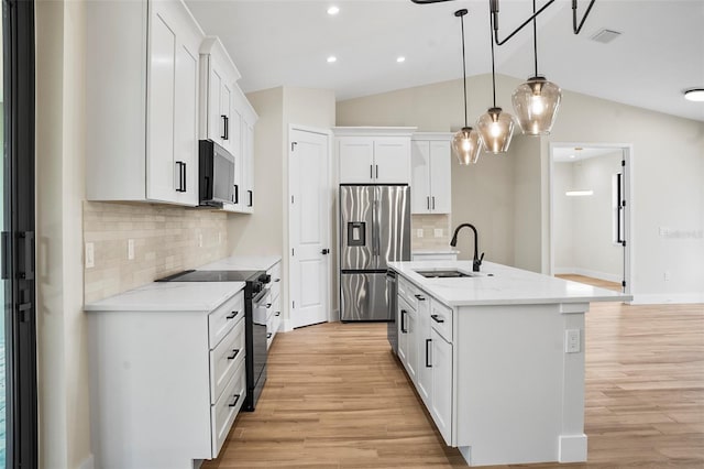 kitchen with sink, stainless steel appliances, white cabinets, an island with sink, and pendant lighting