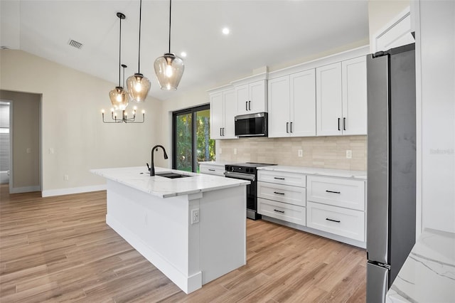 kitchen with a kitchen island with sink, stainless steel appliances, hanging light fixtures, white cabinets, and sink