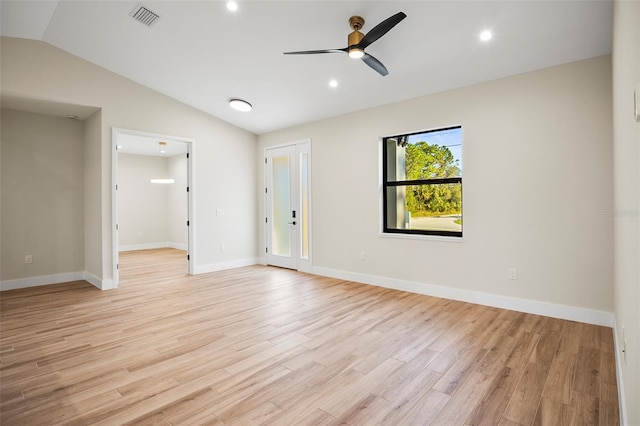 empty room featuring ceiling fan, vaulted ceiling, and light hardwood / wood-style flooring