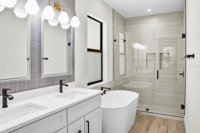 bathroom featuring vanity, separate shower and tub, and hardwood / wood-style floors