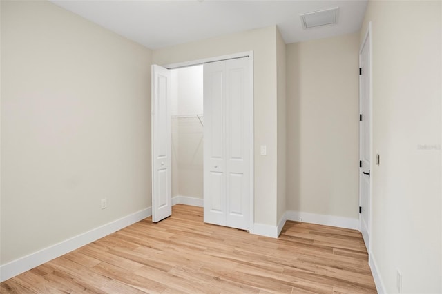 unfurnished bedroom featuring a closet and light hardwood / wood-style flooring