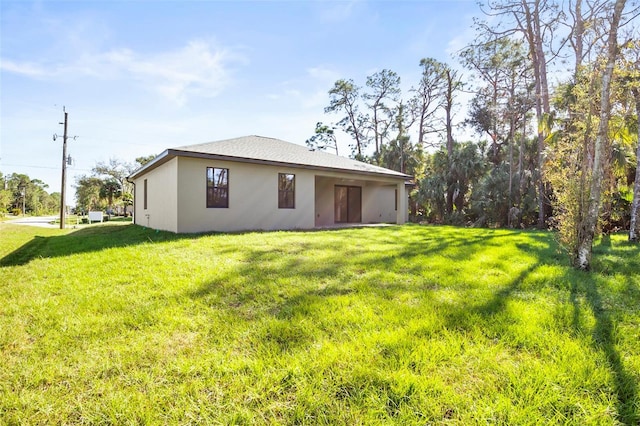 rear view of house featuring a yard