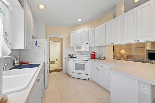 kitchen with white cabinetry, sink, and electric range oven