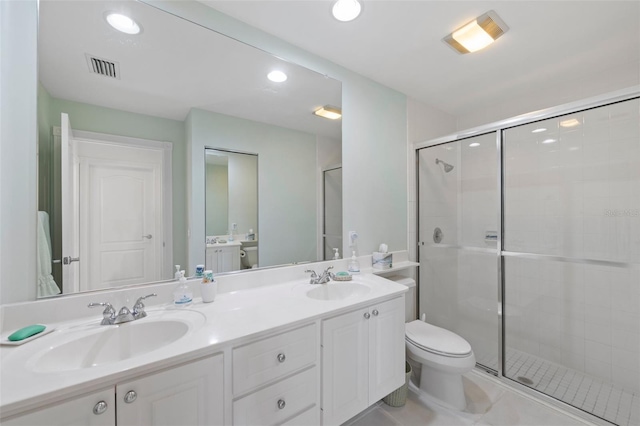 bathroom with tile patterned flooring, vanity, an enclosed shower, and toilet