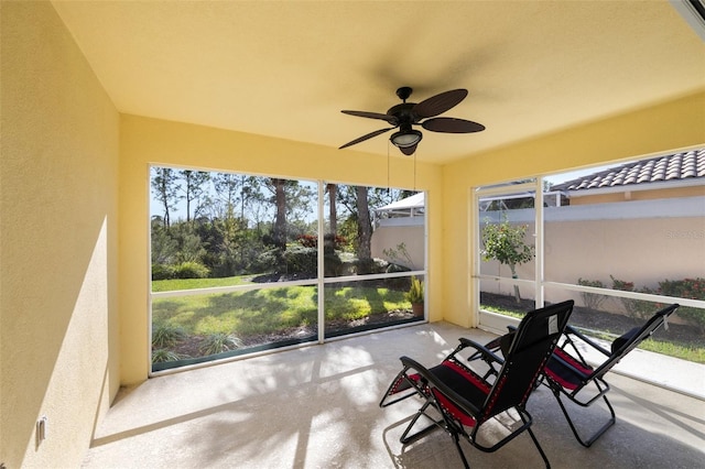 sunroom / solarium featuring ceiling fan