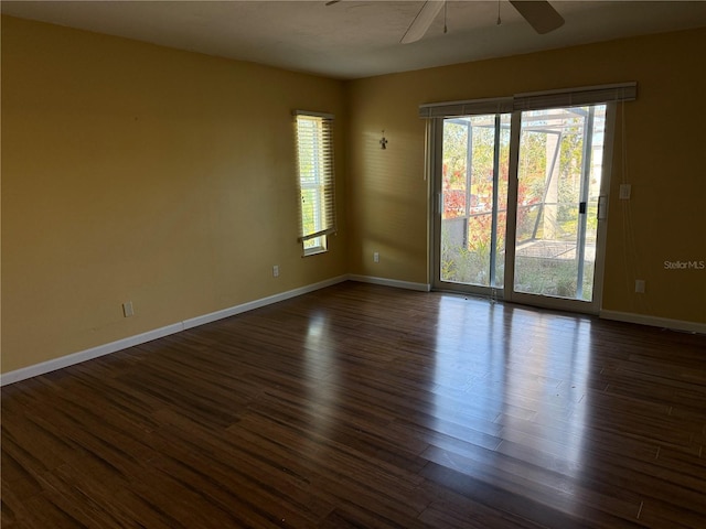 spare room featuring ceiling fan and dark wood-type flooring