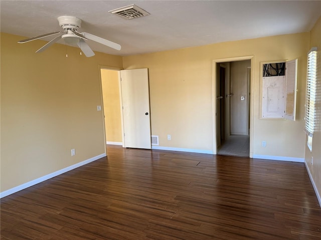 empty room with ceiling fan and dark hardwood / wood-style flooring